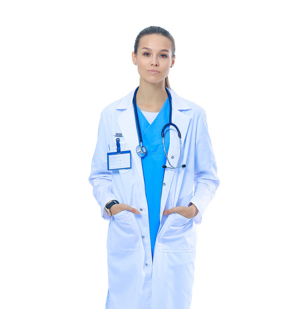 Beautiful young woman in white coat posing with hand in pocket. - Photo, image