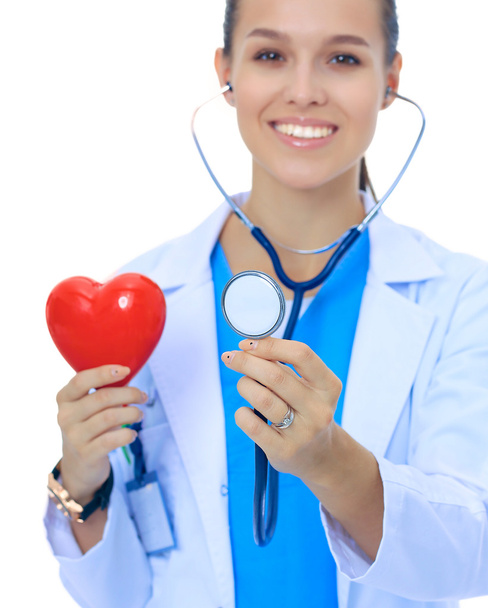 A doctor with stethoscope examining red heart, isolated on white - Foto, immagini