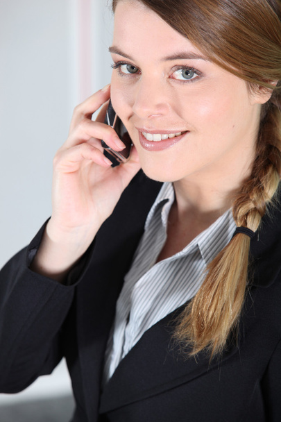 Young businesswoman smiling on the phone. - Zdjęcie, obraz