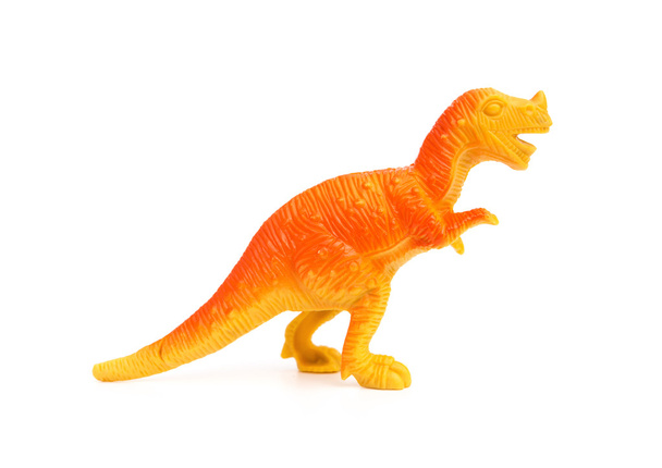 vista lateral brinquedo de dinossauro de plástico laranja em um fundo branco
 - Foto, Imagem