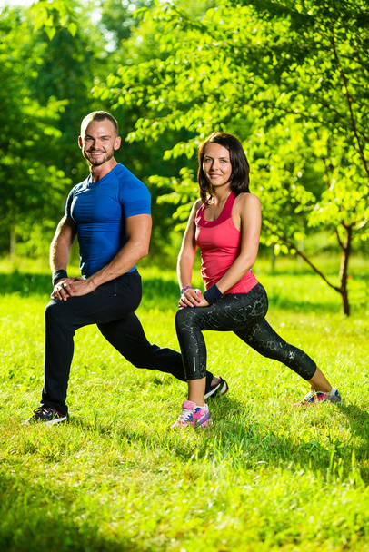 Man and woman doing stretching exercises - Foto, Imagen