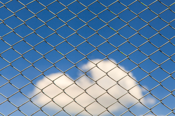 Wired fence on blue sky background - Photo, Image