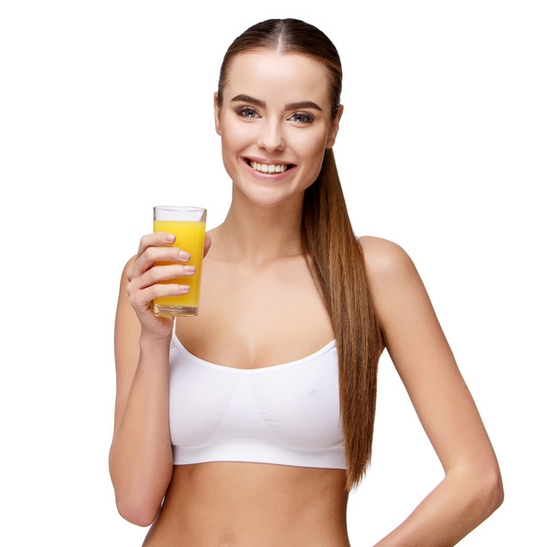 attractivesmiling woman holding glass of orange juice isolated on white - Foto, immagini