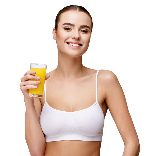attractivesmiling woman holding glass of orange juice isolated on white - Photo, image