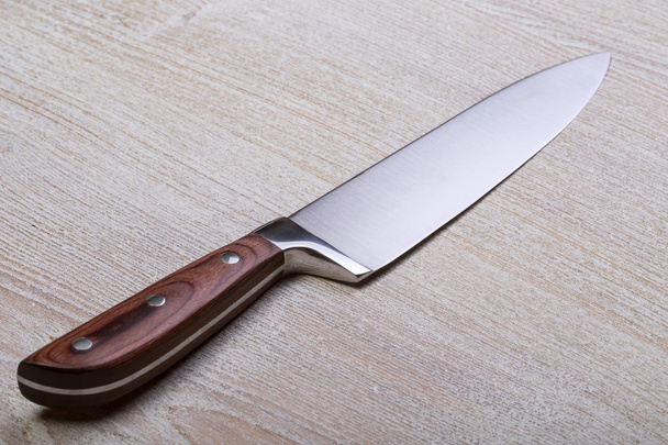 Knife on rustic kitchen table - Фото, зображення