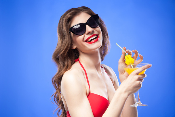 Cheerful model in bikini with drink - 写真・画像