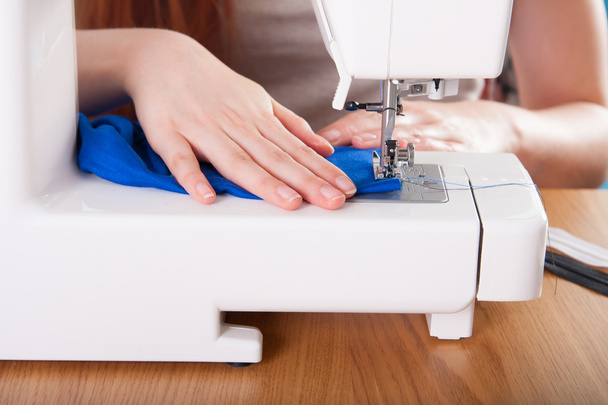 Young woman sewing fabric  - Foto, Imagen