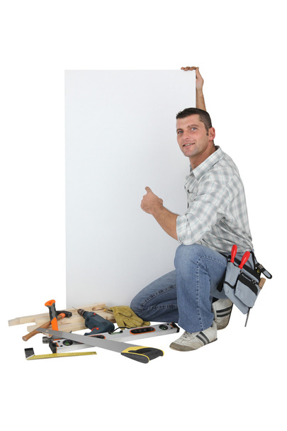 Carpenter posing by advertising panel - Foto, afbeelding