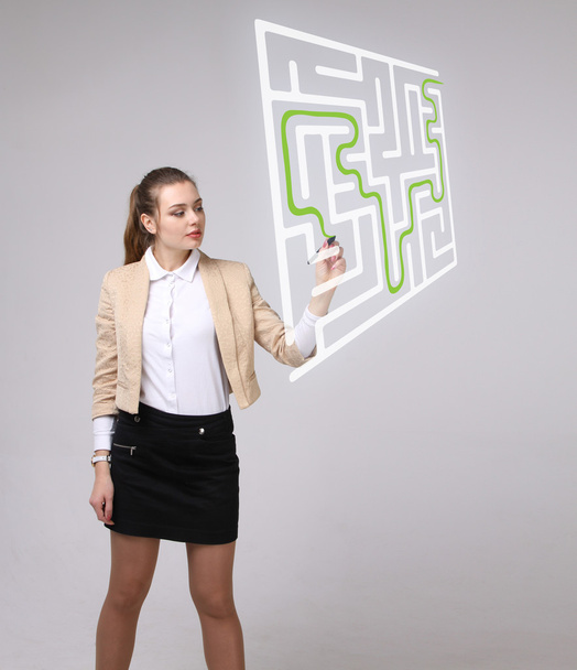 Young woman finding the maze solution, writing on whiteboard. - Foto, immagini