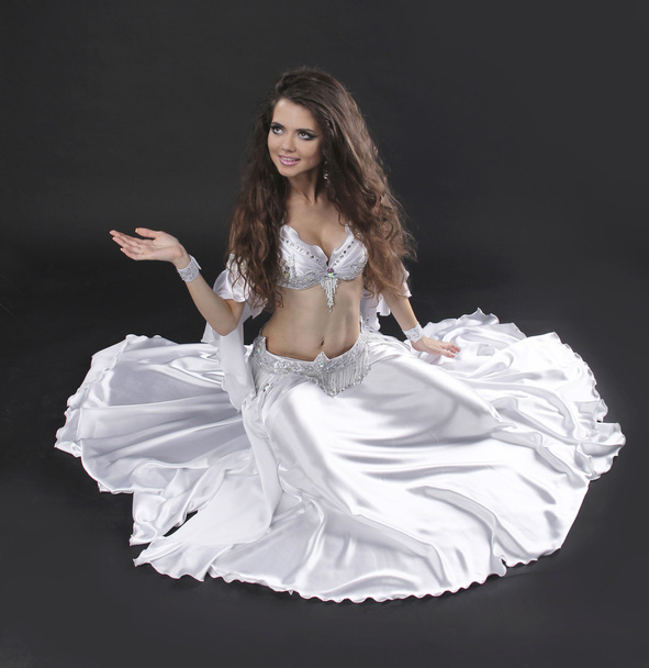 Beautiful exotic belly dancer woman over black background - Photo, Image