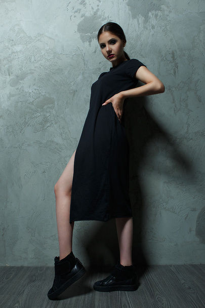 woman fashion model in the studio in a black mantle - Zdjęcie, obraz