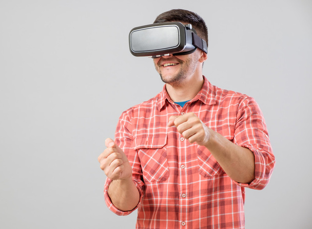 Man with virtual reality glasses paying car simulator - Photo, Image