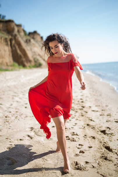 Attractive girl in a smart dress red - Foto, imagen