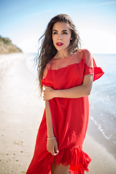 Attractive girl in a smart dress red - Photo, Image