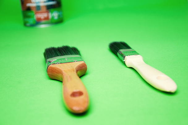 Brush and paint on a green background - Photo, Image