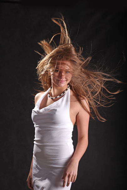 developing in the wind the hair on black background - Фото, изображение