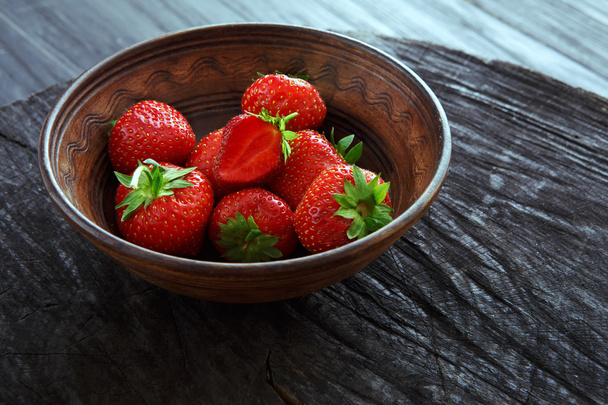 Red fresh strawberries on black rustic wood background - Foto, imagen