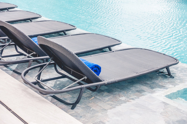 Chair around swimming pool - Фото, изображение