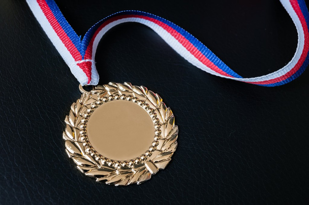 Golden medal for first place on black background. - Photo, Image