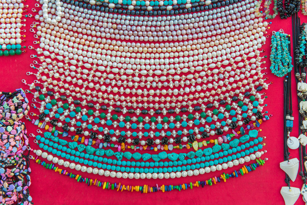 Hand made of Colorful necklaces and bracelets from coral or bead - Photo, Image