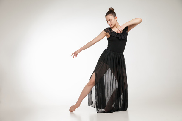 Young ballet dancer wearing black transparent dress dancing - Fotografie, Obrázek