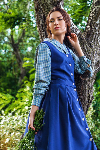 outdoor portrait of a beautiful brunette woman in blue dress in  - Photo, image