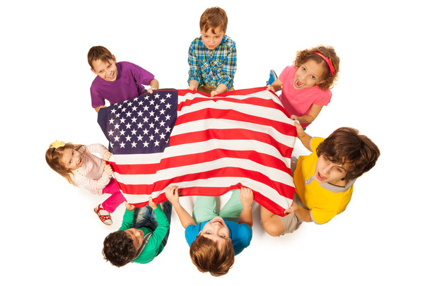 Children in a circle around the flag of America - Фото, зображення