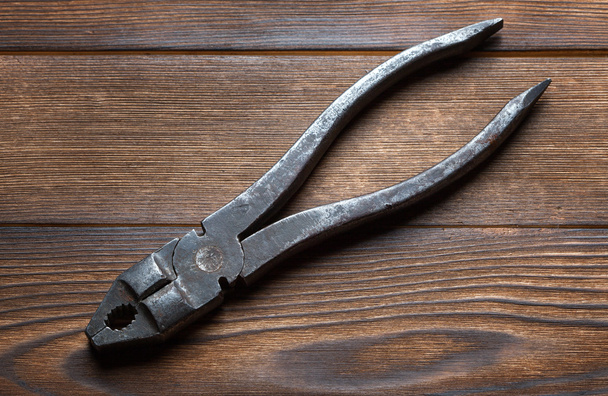 old rusty pliers on wooden background - Photo, Image