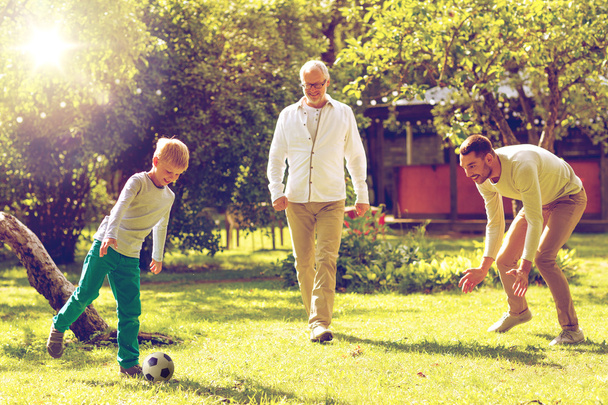 happy family playing football outdoors - Fotografie, Obrázek