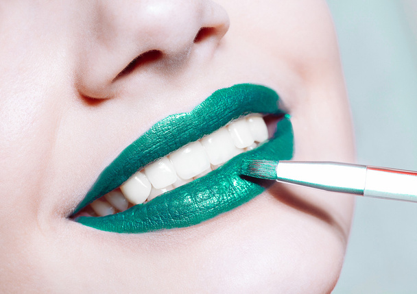 Woman  lips with glossy green lipstick - Фото, изображение