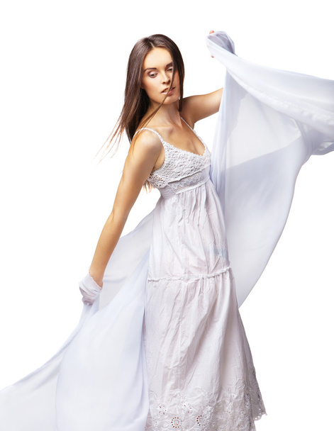 Young woman dancing in gorgeous white dress - 写真・画像