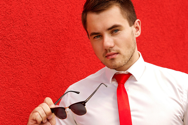 Portrait of a young male businessman in sunglasses - 写真・画像