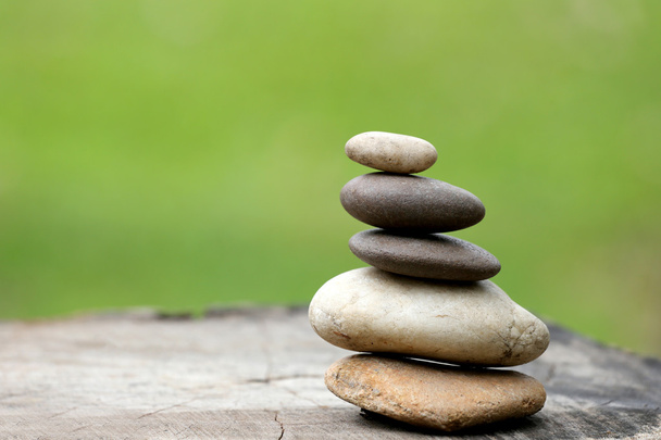 Balance Stones stacked to pyramid in the soft green background. - Photo, Image