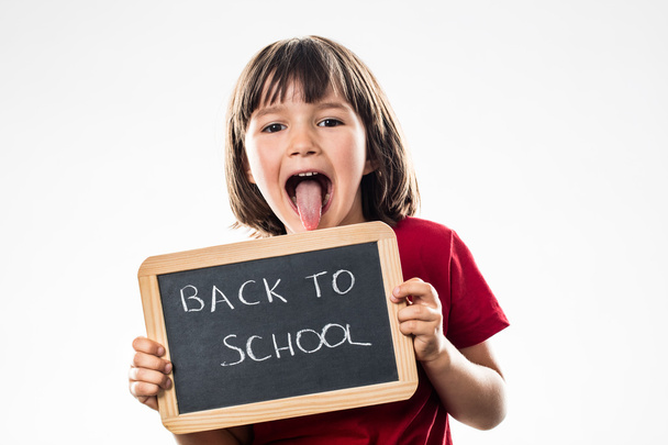 cheeky preschooler sticking out tongue for back to school - Foto, Bild