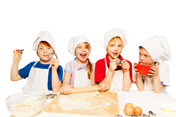  kids in aprons and toques - Фото, изображение