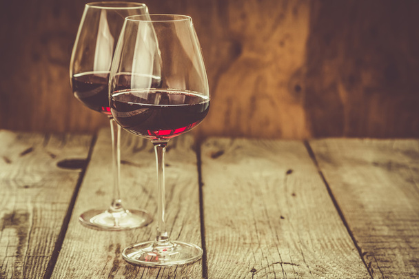 Glasses with red wine on rustic wood background - Fotografie, Obrázek