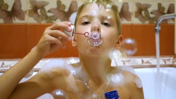 un niño juega con burbujas de jabón en el baño
 - Imágenes, Vídeo
