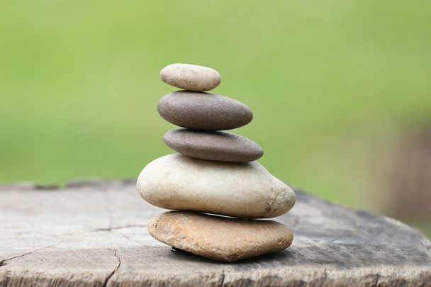 Balance Stones stacked to pyramid in the soft green background. - Photo, Image