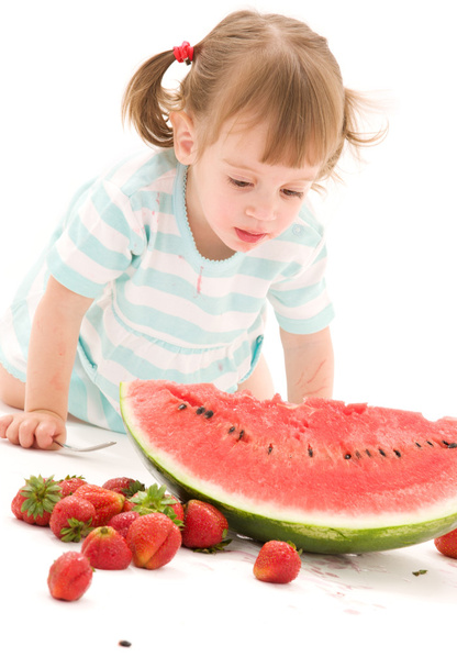 Little girl with strawberry and watermelon - Fotó, kép