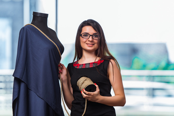 Woman tailor working on new clothing - Fotó, kép