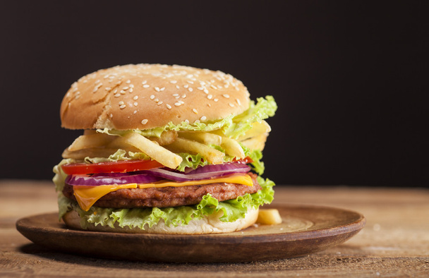 Fresh burger on wooden background - Foto, afbeelding