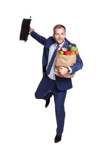 Happy man run with healthy food bag, grocery buyer isolated - Фото, зображення