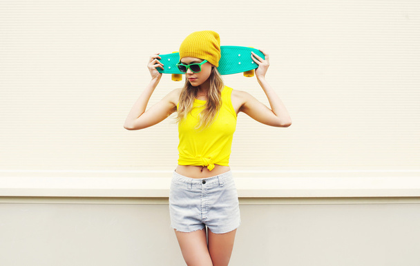 Fashion pretty girl with skateboard over white background - Foto, imagen