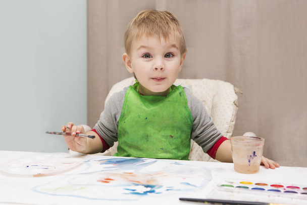 Happy cheerful child drawing with brush  - Photo, image