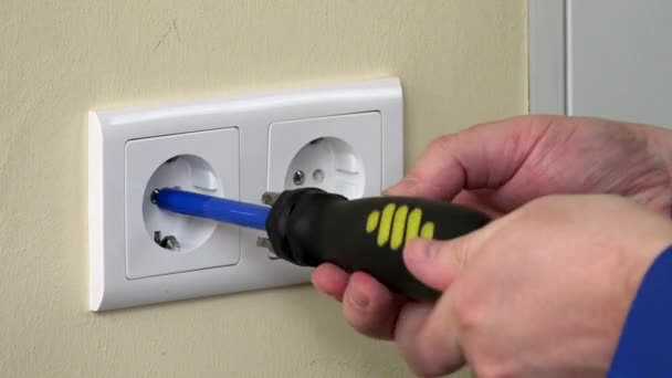 close up of male hands with screwdriver unscrew electrical outlet - Footage, Video