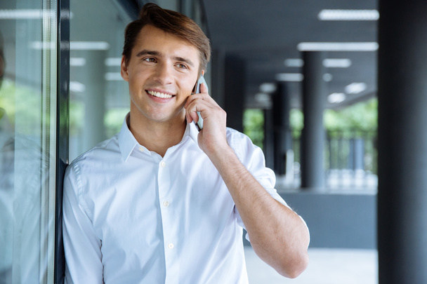Happy young businessman talking on cell phone - Photo, image