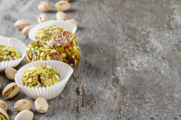 Eastern sweets. Turkish delight with pistachios in a vase. Dark  - Fotó, kép