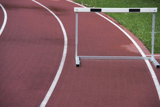 red running athletic track with hurdle, bad weather, wet - Fotoğraf, Görsel