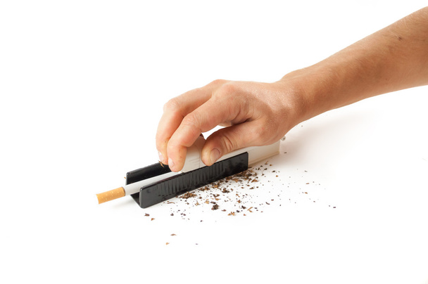 Male hands stuffed tobacco into cigarettes - Photo, Image