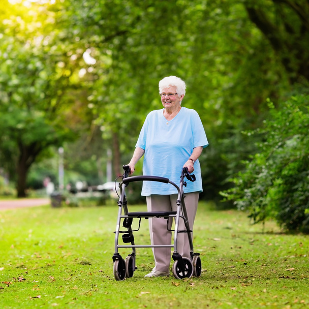 Senior lady with a walker - Photo, Image